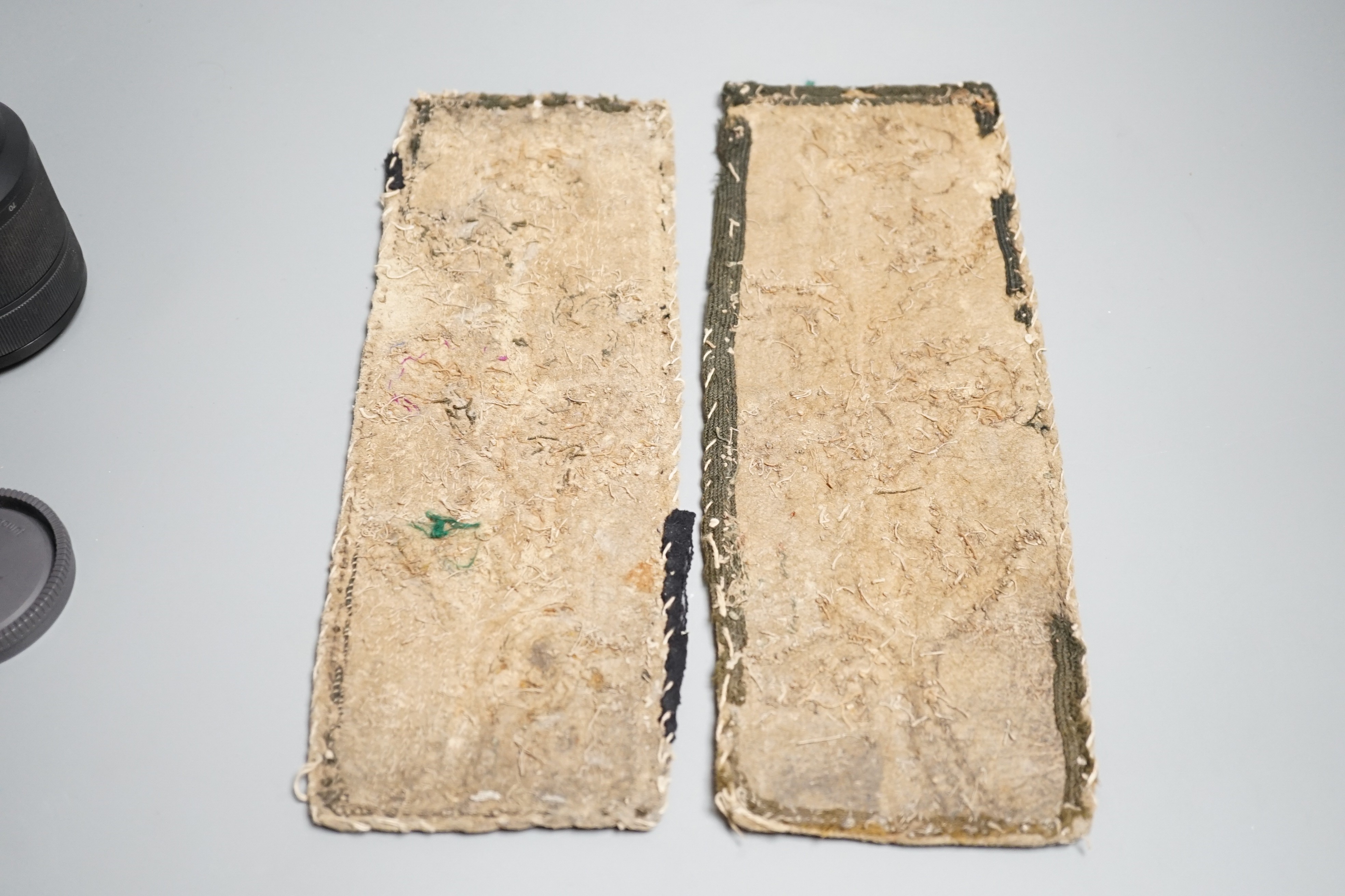 A fine pair of Native American Plains Indian rectangular beadwork panels, with floral designs and tribal markings, leather backing with remains of fabric edges, length 30cms